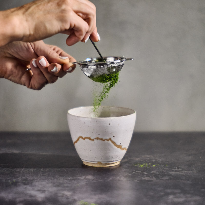 straining matcha tea