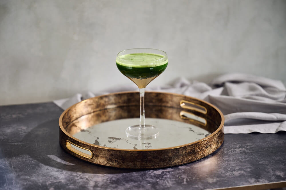 Matcha tea in glass on tray