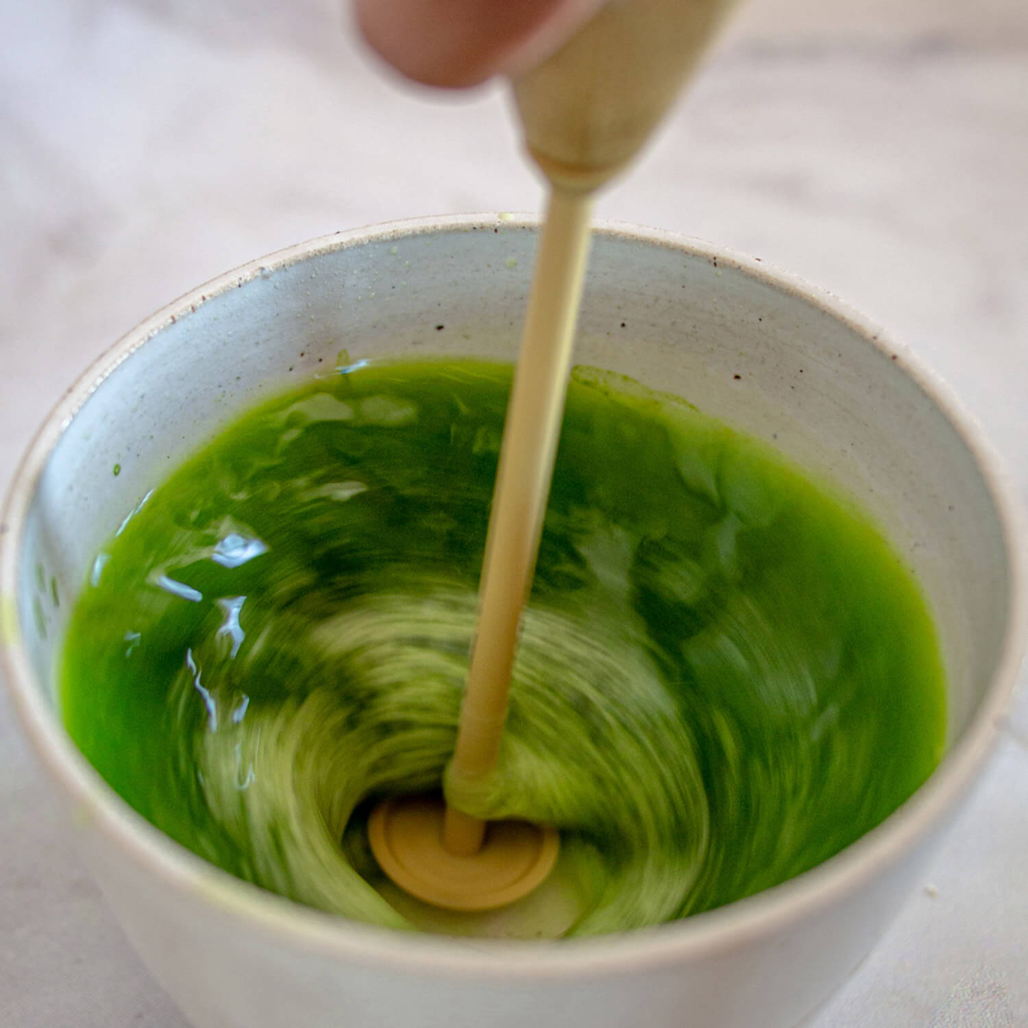 whisking matcha tea