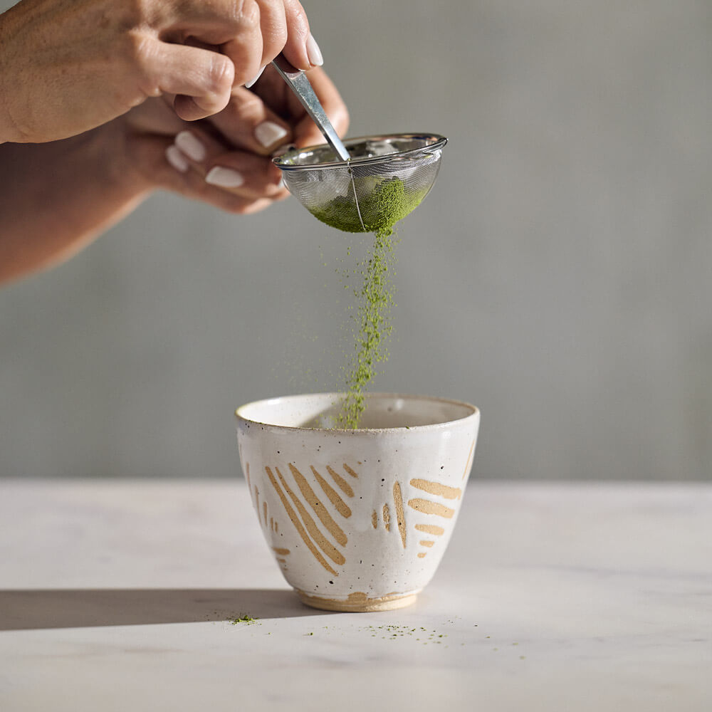 matcha tea being strained